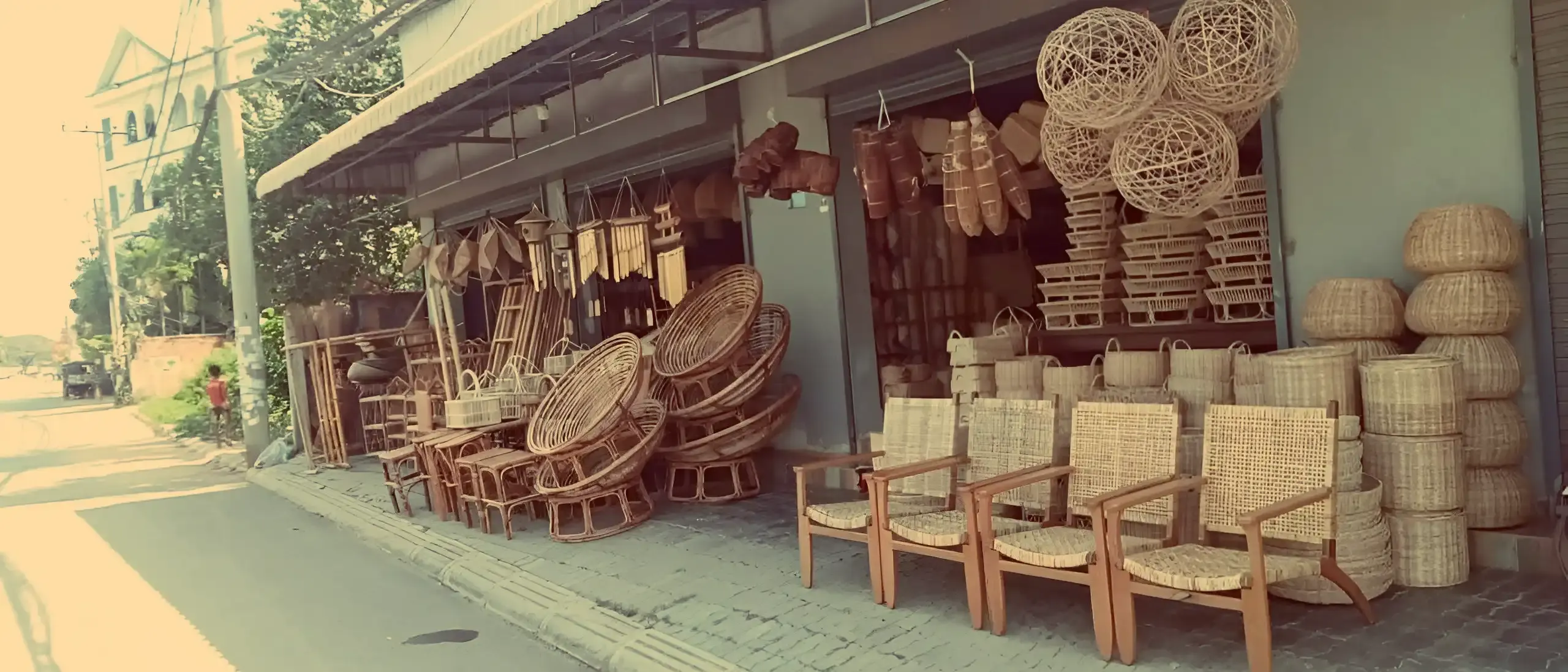 The L&O Rattan Interiors storefront on Sala Kamreuk Road, with papasan chairs, woven pendant shades and baskets displayed on the sidewalk