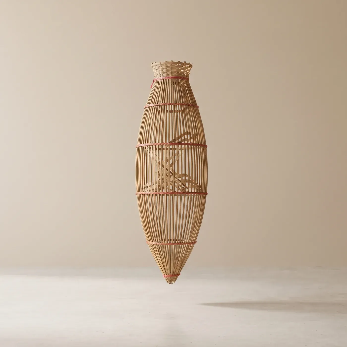 Conical bamboo, reddish rattan ties, pointed end